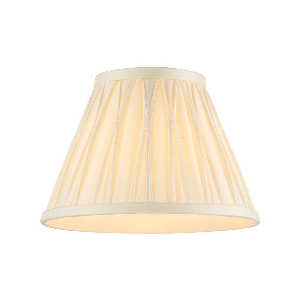 Bevdon 20cm tapered lamp shade in ivory silk with hand-stitched pinch pleats and cream trim, shown on a plain white background.