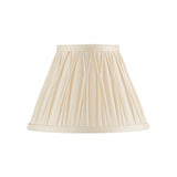 Bevdon 20cm tapered lamp shade in ivory silk with hand-stitched pinch pleats and taped edges, shown on a plain white background.
