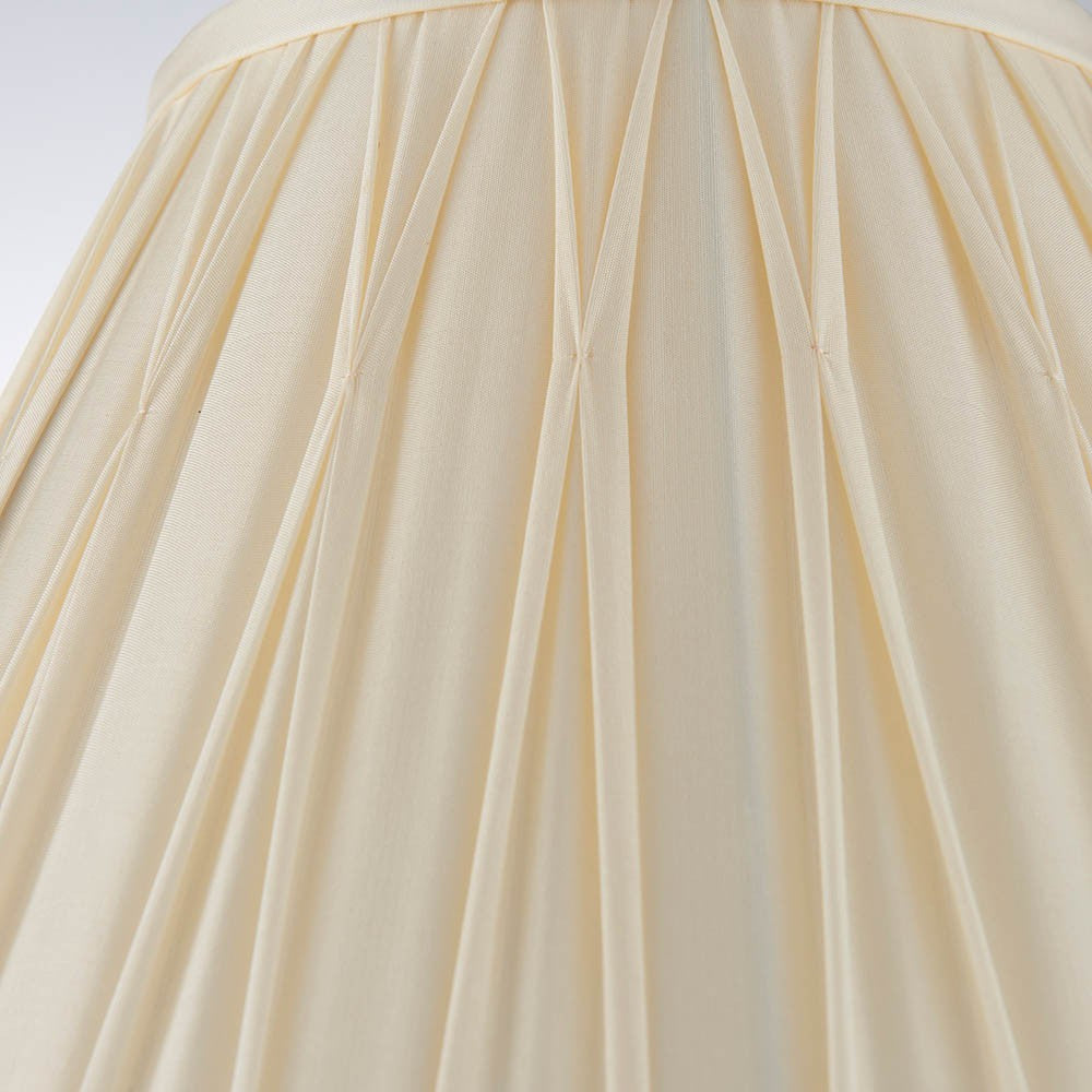Close-up of Endon Bevdon 30cm tapered lamp shade in ivory silk, showing hand-stitched pinch pleats and box pleat detailing against a light background.
