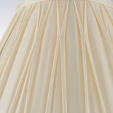 Close-up of Endon Bevdon 30cm tapered lamp shade in ivory silk, showing hand-stitched pinch pleats and box pleat detailing against a light background.