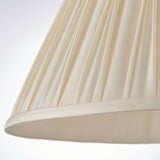 Close-up of the Bevdon 35cm tapered lamp shade in ivory silk, showing hand-stitched pinch pleats and a taped edge trim.