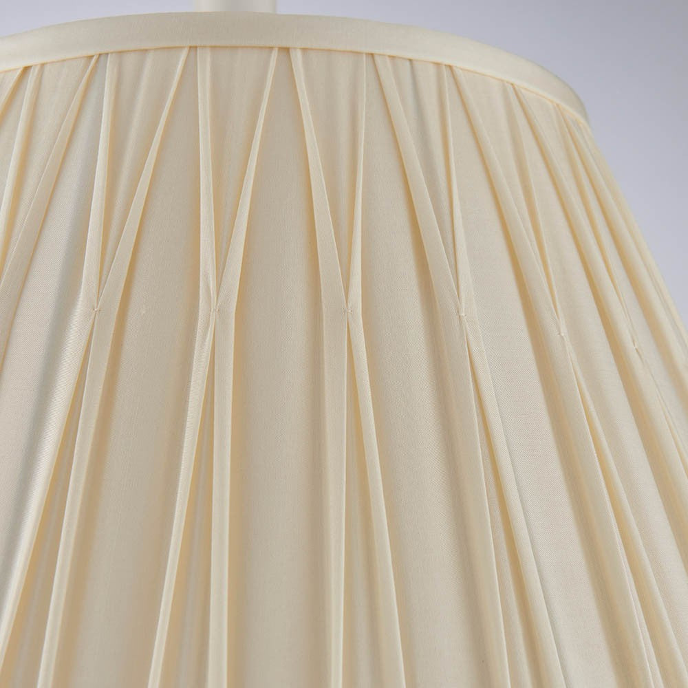 Close-up of Endon Bevdon 40cm tapered lamp shade in ivory silk, showing hand-stitched pinch pleats and box pleat detail against a plain background.