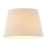 Endon Bevhurst 20cm tapered lamp shade in cream linen-effect fabric with a rolled edge, shown illuminated against a plain white background.