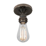 Bexter Vintage Brass Flush Ceiling Light with round ceiling plate and single knurled E27 lampholder holding a bare filament bulb, shown against a plain white background.