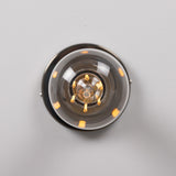 Bexter Vintage Brass Flush Ceiling Light, close-up view of the round brass plate and single E27 lampholder with knurled rings and bare bulb, shown against a plain light grey background.