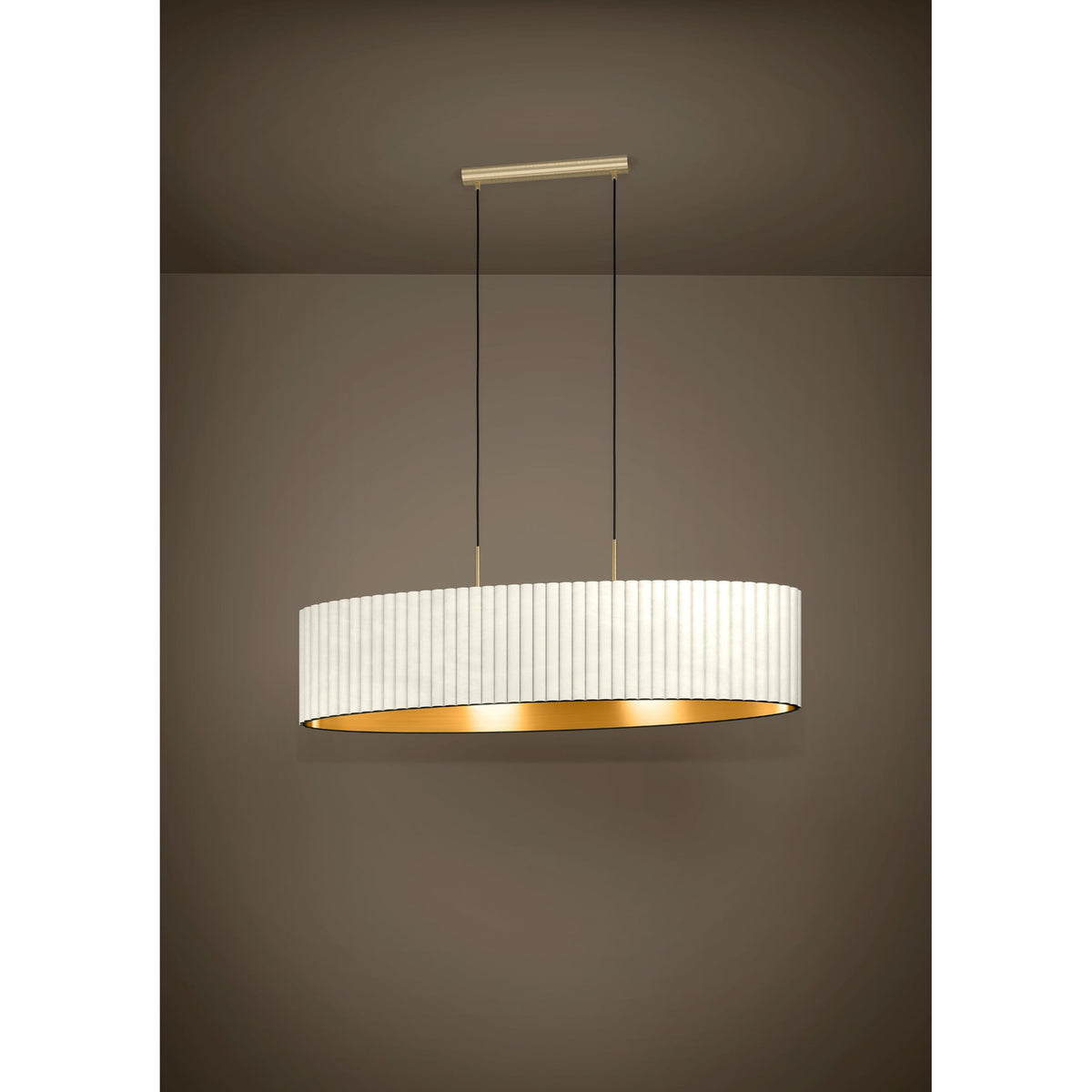 Birbenne 2 Light Pendant in brushed brass, with a long oval pleated white velvet shade lined in gold, suspended on two black cords from a slim ceiling bar.