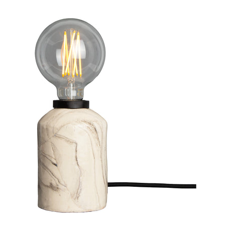 Bixa Ceramic Table Lamp in Marbled finish, a short cylindrical base with swirled cream and grey glaze, black E27 lampholder, exposed globe bulb, and black fabric cable, shown on a white background.