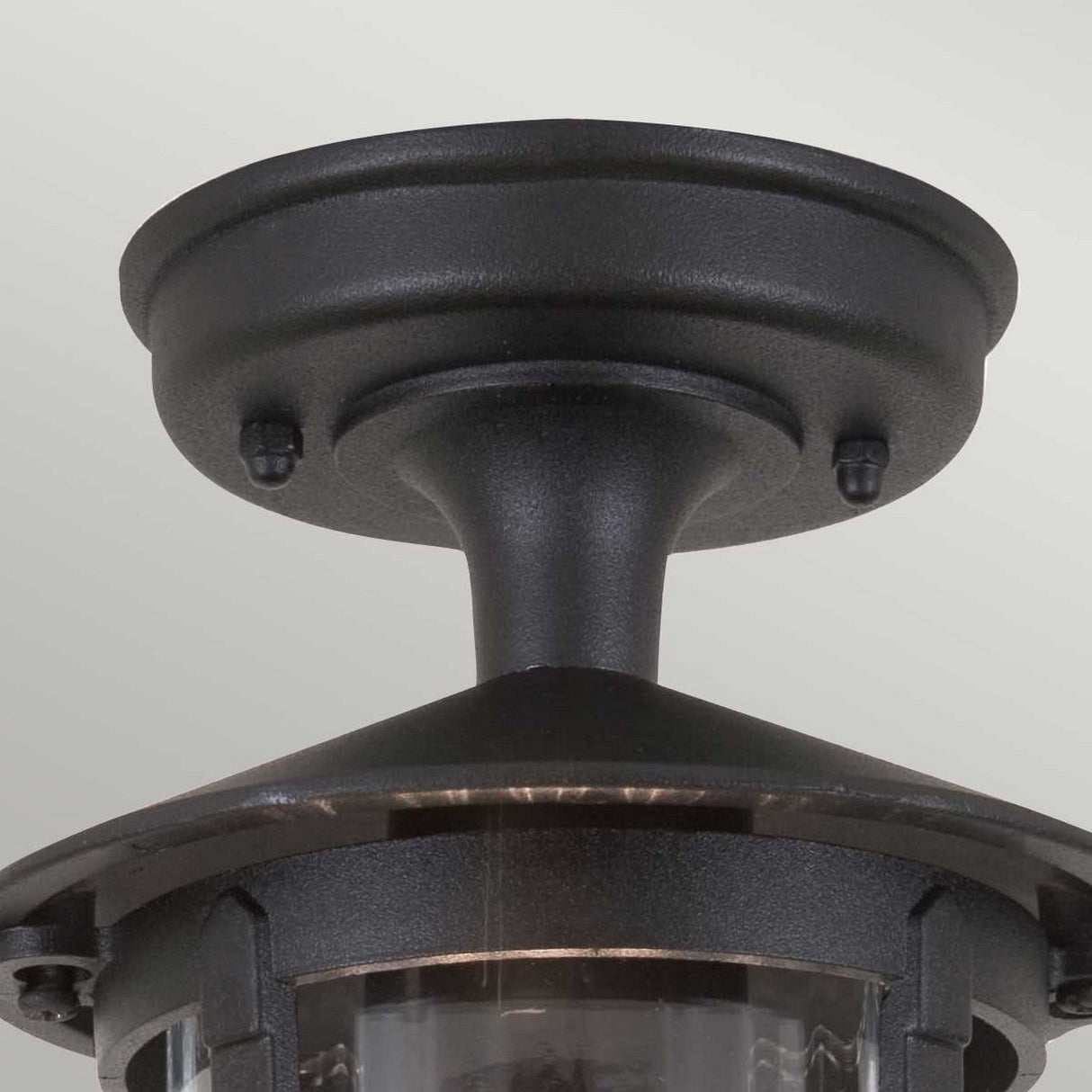 A close-up of the Hereford-1 1 Light Outdoor Porch Lantern in black features a traditional lantern design with a round base and short stem. The glass enclosure is crafted to hold a light bulb, making it the ideal choice for blending style with functionality as an outdoor porch light.