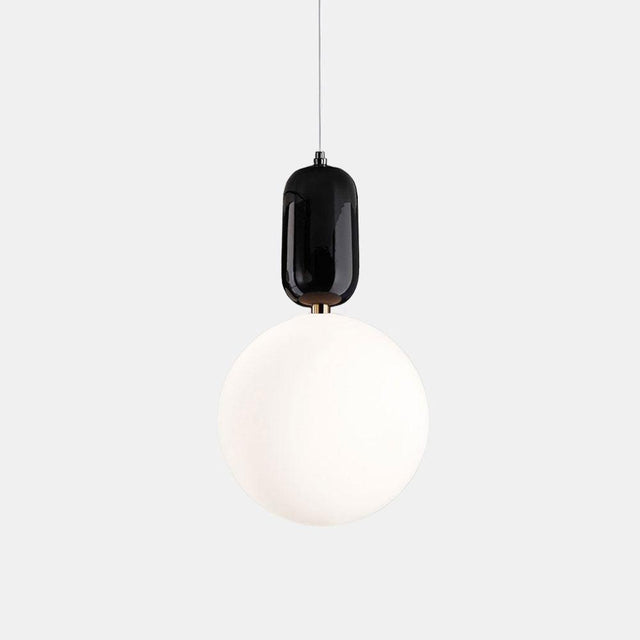 The Pallo Pendant Light - Black highlights a minimalist design with its glossy black fixture and spherical white bulb, all suspended from a slender cord, set against a plain gray backdrop to exude European elegance.