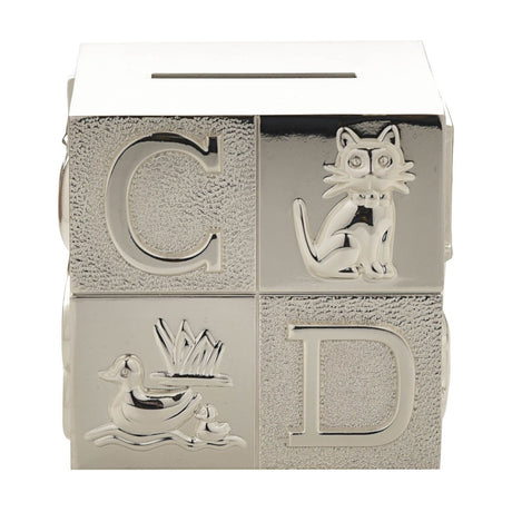 Silverplated cube-shaped money box with raised letters C and D, a sitting cat and a duck with duckling design, coin slot on top, set against a plain white background.