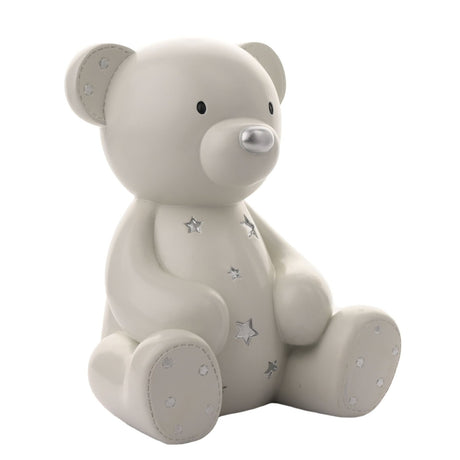Large Teddy Bear Resin Money Box, 19cm, in white, sitting upright with silver stars on its tummy, silver nose, and dotted ear and foot pads, on a plain white background.