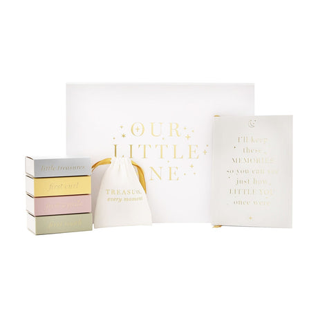 "Our Little One" baby keepsake box set in white with gold lettering, including four pastel matchbox-style boxes, a notebook, and a drawstring pouch on a plain background.