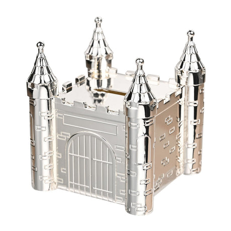 Silverplated metal castle money box with turreted corners, scalloped roofs, crenellated walls, raised brickwork, and an arched gate with portcullis grille.