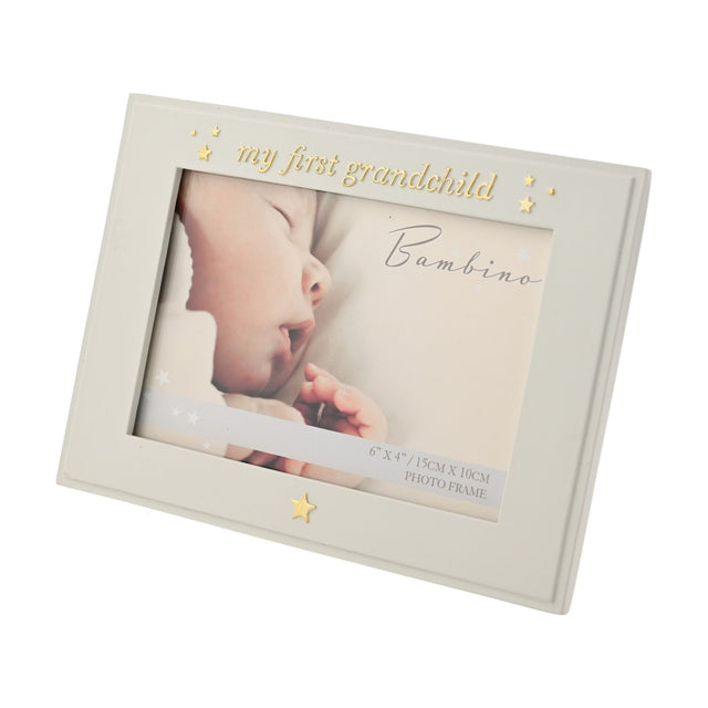 Cream resin photo frame with "My First Grandchild" in gold-tone script and star details, holding a 6 x 4in landscape photo, shown on a white background.