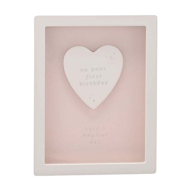 1st Birthday Heart Framed Wooden Plaque in white and pink, featuring a raised white heart reading "on your first birthday" with "have a magical day" below, on a plain background.