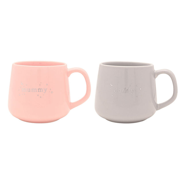 Set of 2 porcelain mugs, "mummy" in pink and "daddy" in grey, with silver lettering, stars and crescent moon detail, rounded handles, on a plain white background.