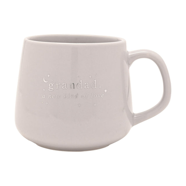 Grey stoneware mug with silver "grandad, a new kind of love" lettering, star and crescent moon details, and a curved handle, shown against a plain white background.