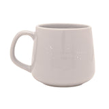 Grey stoneware mug with a curved handle, featuring silver "a grand adventure begins" text with star and crescent moon details, shown on a plain white background.