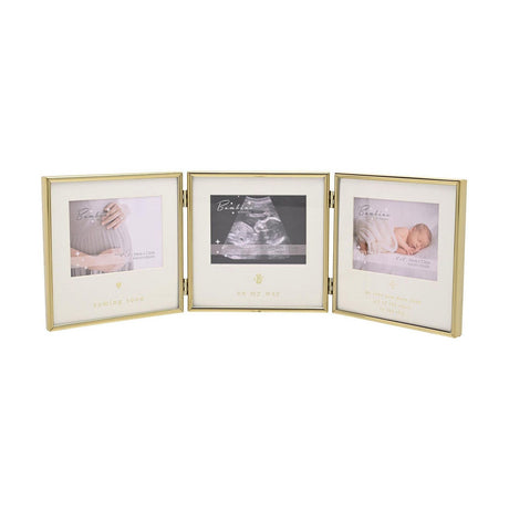 Triple baby scan photo frame with three hinged gold steel panels and cream mounts, each 4 x 3in opening captioned "coming soon," "on my way," and a starry message, shown on a white background.