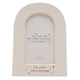 Cream ceramic arched photo frame with "on your christening" in silver foil and star details, holding a 6 x 4in print, shown on a white background.