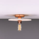 Bog Oak ceramic ceiling light with a flat round Matt White Striped disc and copper-finish fitting, holding a single exposed bulb against a plain background.