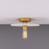 Bog Oak ceramic ceiling light with a flat round matt white striped disc, brass ceiling mount and lampholder, fitted with a bare bulb, shown against a plain grey background.