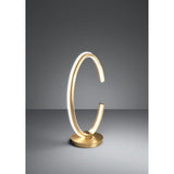Bogado LED Table Lamp in gold-coloured steel, an open C-shaped ring with a glowing white diffuser line, set on a round disc base against a plain grey background.