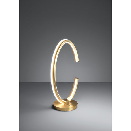 Bogado LED Table Lamp in gold-coloured steel, an open C-shaped ring with a glowing white diffuser line, set on a round disc base against a plain grey background.