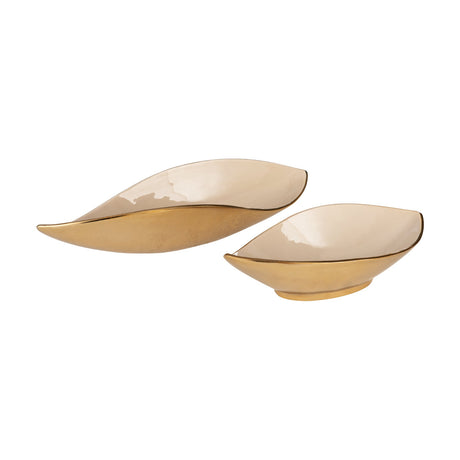 Bongosi Decorative Bowl, two leaf-shaped aluminium dishes with gold exteriors, glossy cream interiors and fine gold rim lines, shown on a plain white background.
