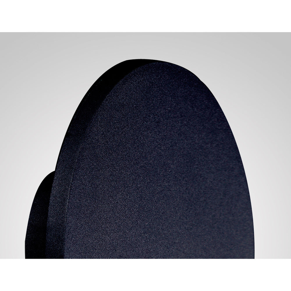 Close-up of the Bora 27cm oval LED wall light showing its matt black metal faceplate and slim flush profile against a plain light background.