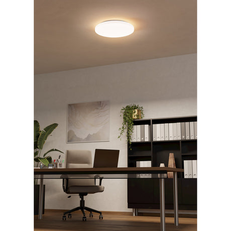 Bosmine LED Flush Ceiling Light 43cm in White, a round low-profile fixture glowing warm white above a desk in a home office setting.