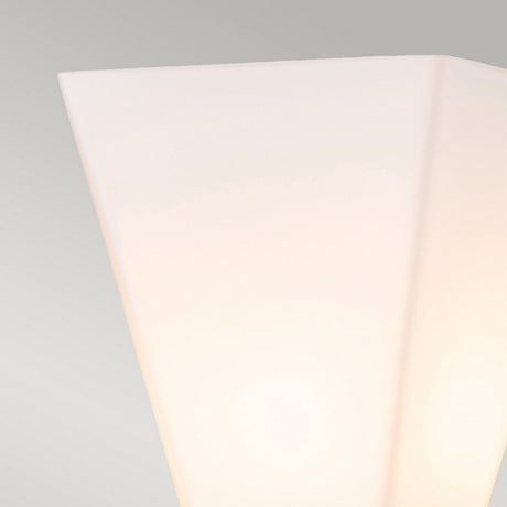 Close-up of the Bowtie 1 Light Wall Light in matte black featuring a soft, diffused glow against a plain gray backdrop, ideal for sleek bathroom lighting.