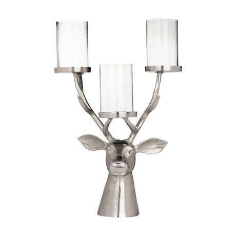 Braawe Candle Holder in nickel-finish aluminium, shaped as a stag's head with branching antlers holding three clear glass hurricane holders, on a plain white background.