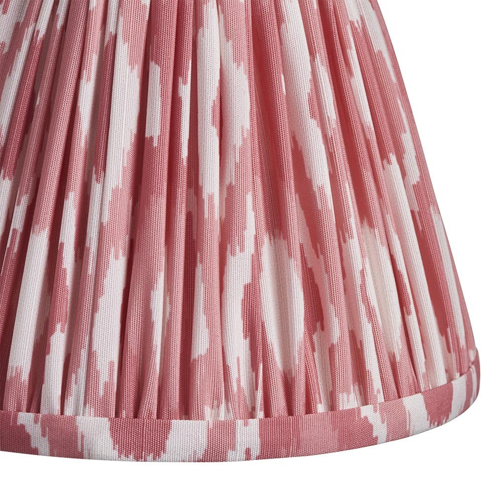 Close-up of Endon Brenwell 16cm tapered lamp shade in coral pink, showing pleated faux silk with ikat print and taped edge trim.