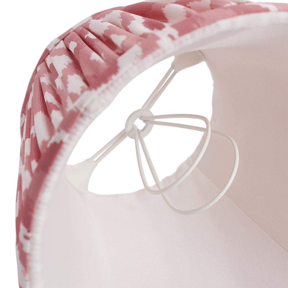 Interior view of the Endon Brenwell 16cm tapered lamp shade in coral pink, showing the pleated ikat faux silk, plain white lining and candle clip fitting.