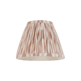 Endon Brenwell 16cm tapered lamp shade in pleated faux silk with a neutral pink and cream ikat print and taped edges, on a plain white background.