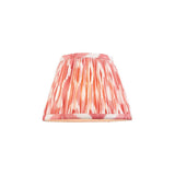 Endon Brenwell 20cm tapered lamp shade in coral pink and white ikat-printed pleated faux silk with taped edges, shown on a plain white background.