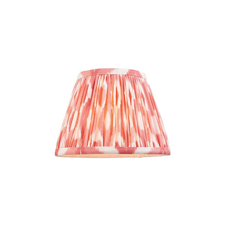 Endon Brenwell 20cm tapered lamp shade in coral pink and white ikat-printed pleated faux silk with taped edges, shown on a plain white background.