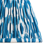 Close-up of Endon Brenwell 20cm tapered lamp shade in marlin blue and white ikat print on pleated faux silk with taped edge detailing.