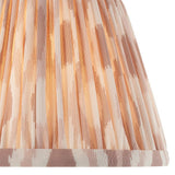 Close-up of Endon Brenwell 20cm tapered lamp shade in neutral, showing pleated faux silk with a soft ikat print in cream and warm beige tones.