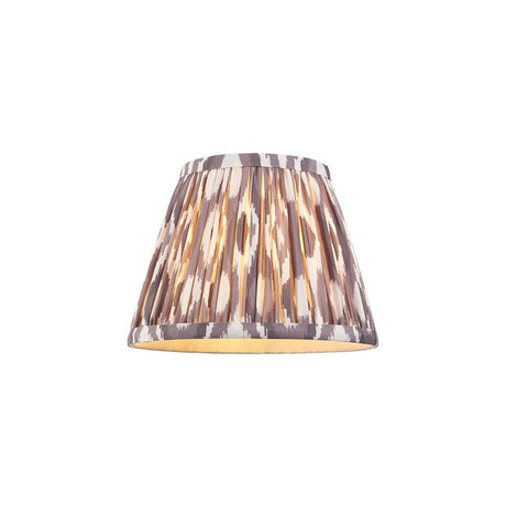 Endon Brenwell 20cm tapered lamp shade in pearl grey pleated faux silk with an ikat pattern and taped edges, shown on a plain white background.