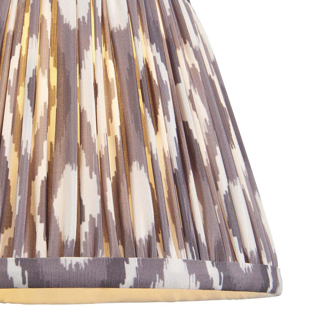 Close-up of Endon Brenwell 20cm tapered lamp shade in pearl grey, showing pleated faux silk with ikat pattern in grey and white tones.