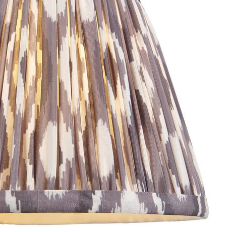 Close-up of Endon Brenwell 20cm tapered lamp shade in pearl grey, showing pleated faux silk with ikat pattern in grey and white tones.