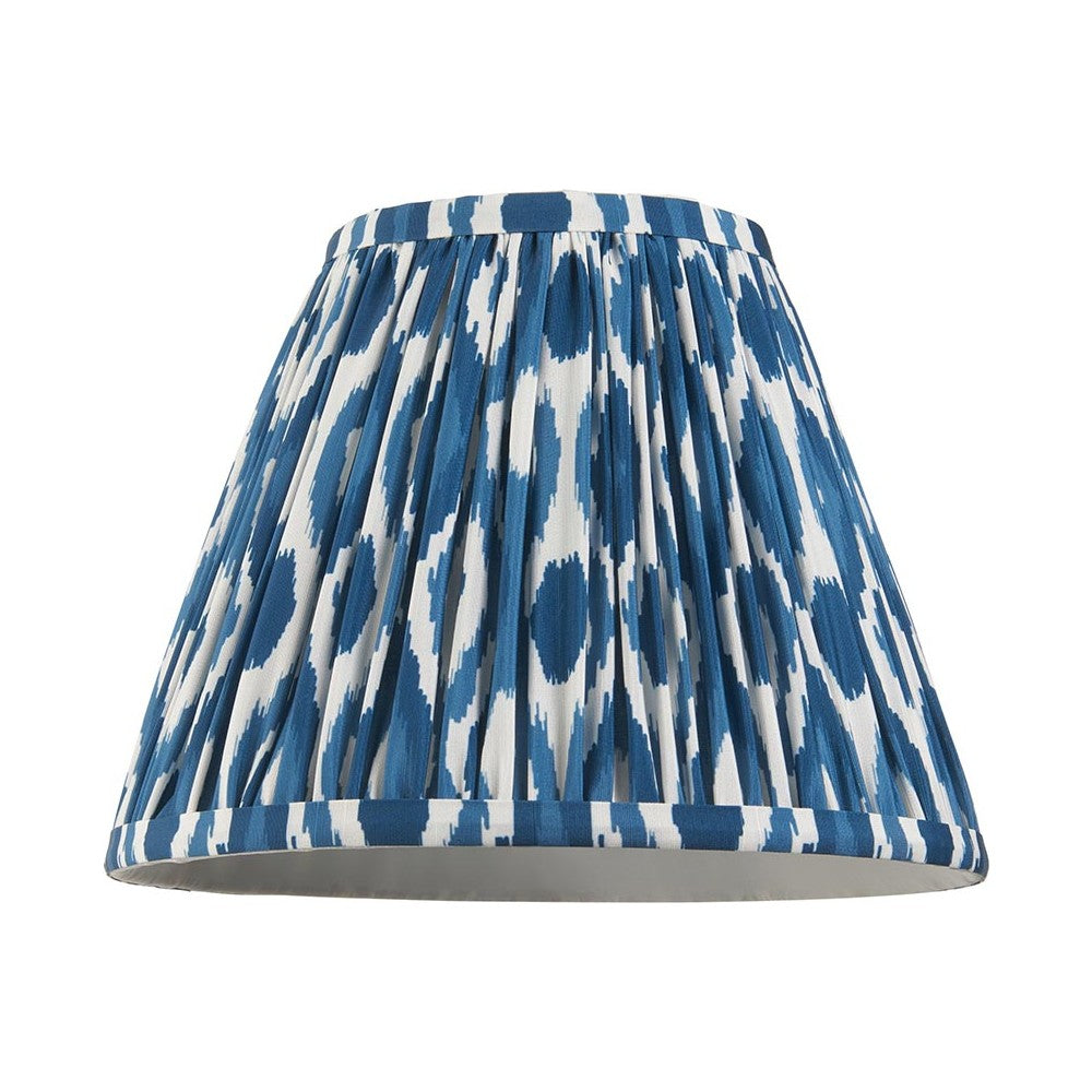 Endon Brenwell 25cm tapered lamp shade in marlin blue and white ikat print faux silk with gathered pleats and taped edges, on a white background.