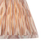 Close-up of the Endon Brenwell 25cm tapered lamp shade in neutral, showing pleated faux silk with an ikat print in soft beige and cream tones.