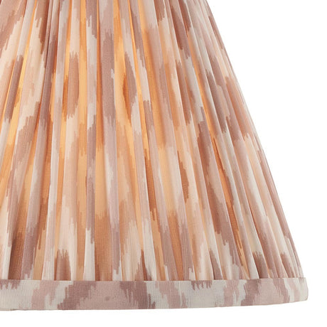 Close-up of the Endon Brenwell 25cm tapered lamp shade in neutral, showing pleated faux silk with an ikat print in soft beige and cream tones.