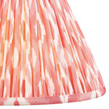 Endon Brenwell 30cm tapered lamp shade in coral pink and white, showing the pleated faux silk fabric with ikat pattern and taped edge trim.