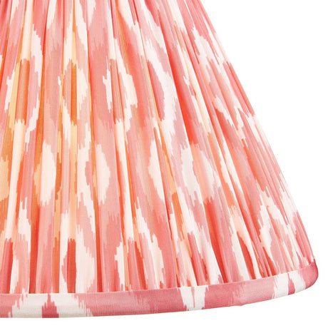 Endon Brenwell 30cm tapered lamp shade in coral pink and white, showing the pleated faux silk fabric with ikat pattern and taped edge trim.