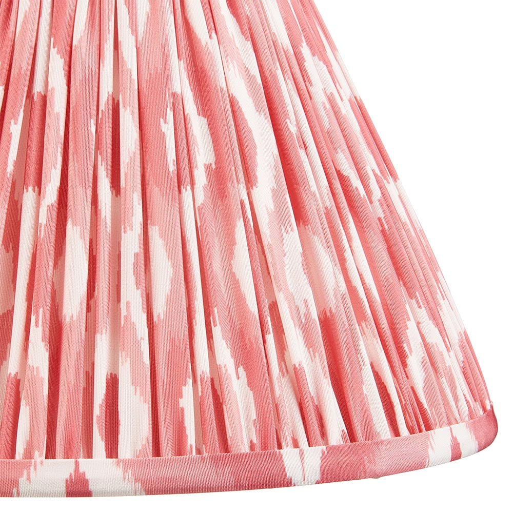 Close-up of Endon Brenwell 30cm tapered lamp shade in coral pink and white ikat print on gathered pleated faux silk with taped edge trim.