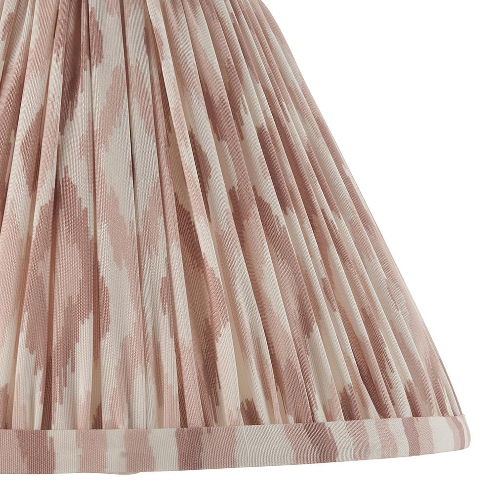 Close-up of Endon Brenwell 30cm tapered lamp shade in neutral, showing pleated faux silk with pink ikat print and taped edge trim.